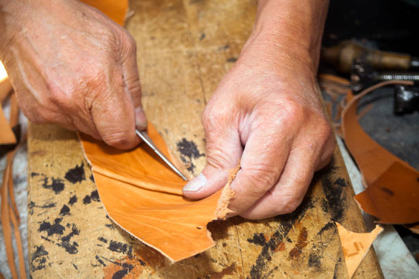 istock Shoemaker's hands manufacturing leather boots and shoes. 839295346