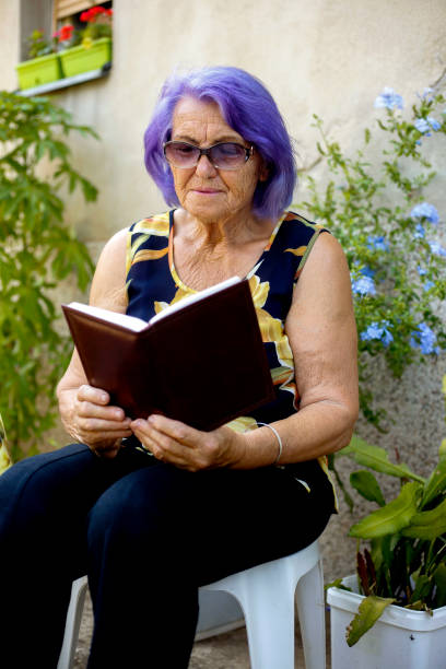 istock Senior woman reading in garden 839314746
