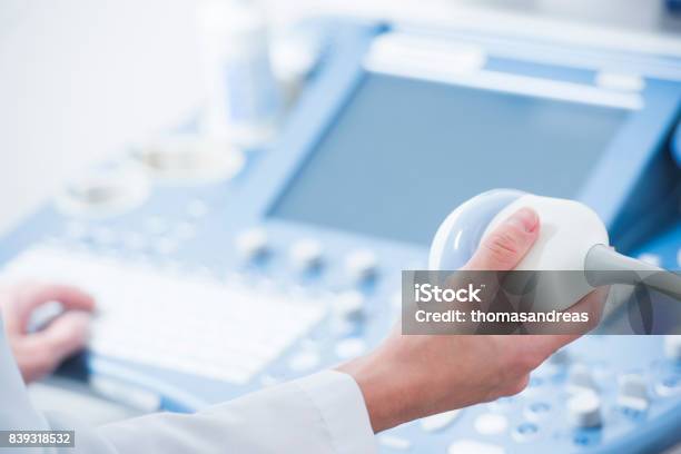 Young Woman Doctors Hands Close Up Preparing For An Ultrasound Device Scan Stock Photo - Download Image Now
