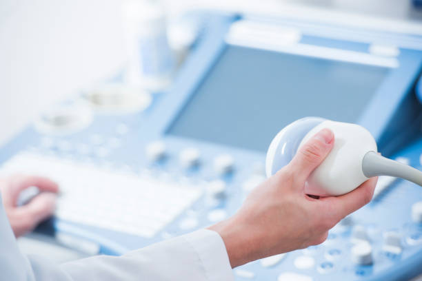 young woman doctor's hands close up preparing for an ultrasound device scan - ultrasound imagens e fotografias de stock