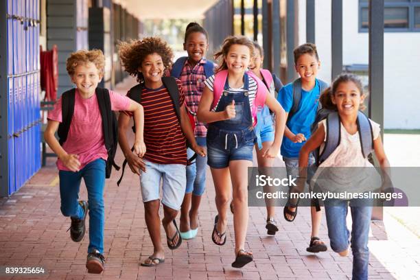 School Kids Running In Elementary School Hallway Front View Stock Photo - Download Image Now