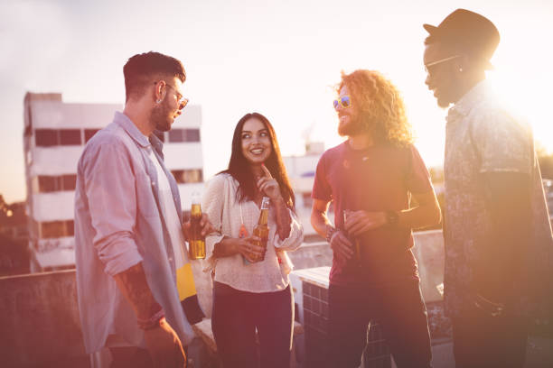 istock Multi-ethnic group of friends having fun at rooftop party 839340912