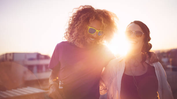 istock Hipster friends with drinks laughing at summer rooftop party 839341114