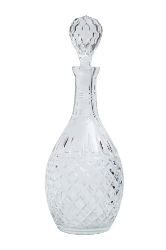 Glass transparent clean empty single shiny beautiful stylish carafe with a plug on isolated white background.