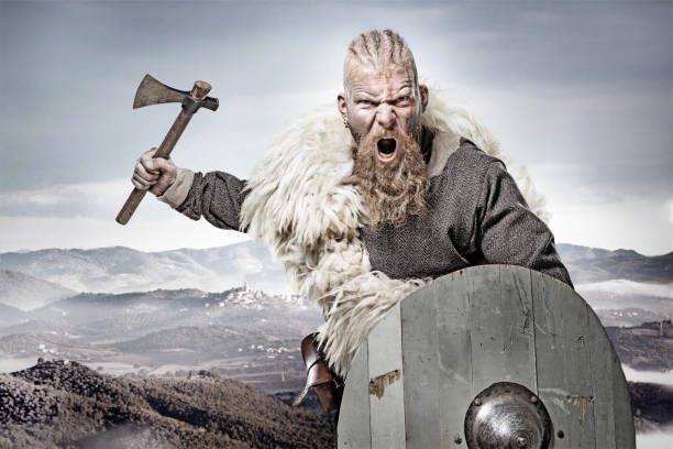 arme maniant sanglante viking warrior dans émotionnelle pose contre la chaîne de montagnes - viking photos et images de collection