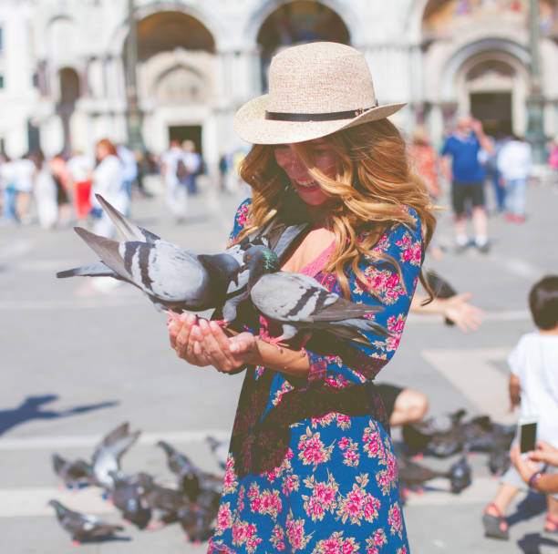 istock Young woman with pigeon 839353764