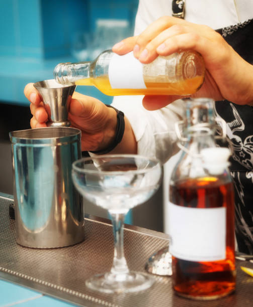 istock Bartender is pouring infusion into a mixing glass, toned 839357238