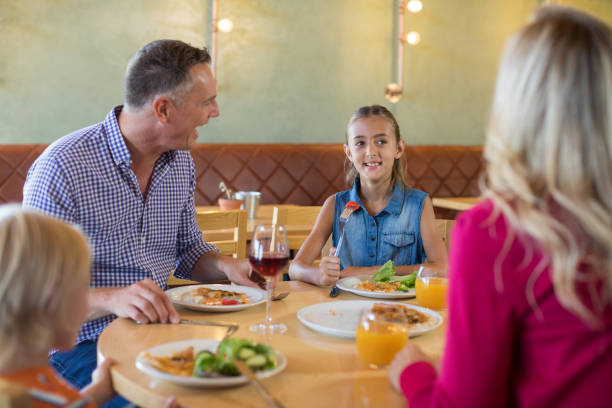 istock Happy family talking while having food 839361354