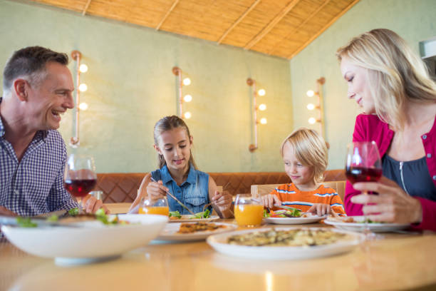 istock Family having dinner at restaurant 839361378