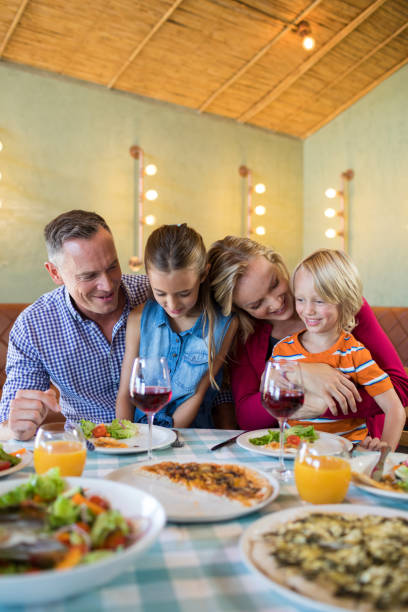 istock Happy family enjoying dinner at restaurant 839361516