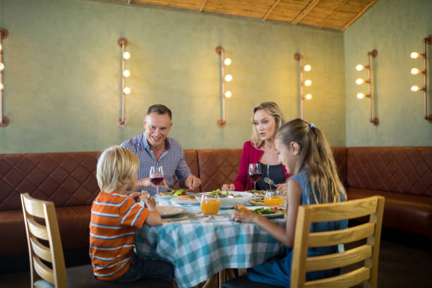 istock Happy family dining at restauranrt 839361574