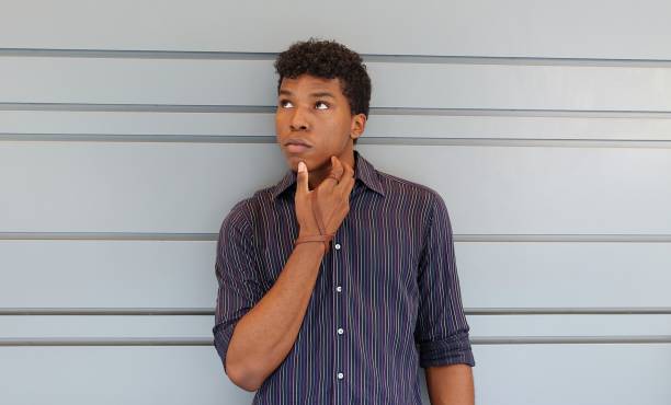 istock Young man standing against a gray wall 839368316