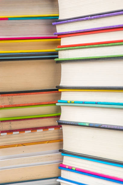 istock Stack of books on a shelf, multicolored book spines. 839371544