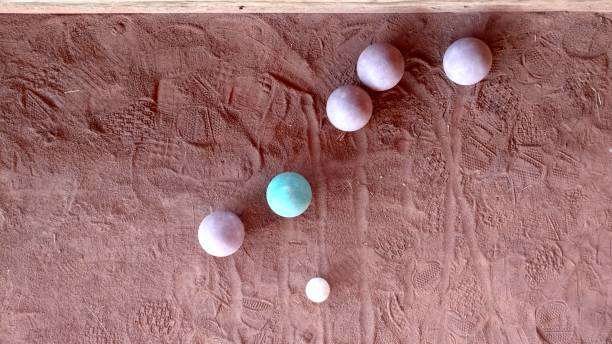 The bocce balls on a green grass.