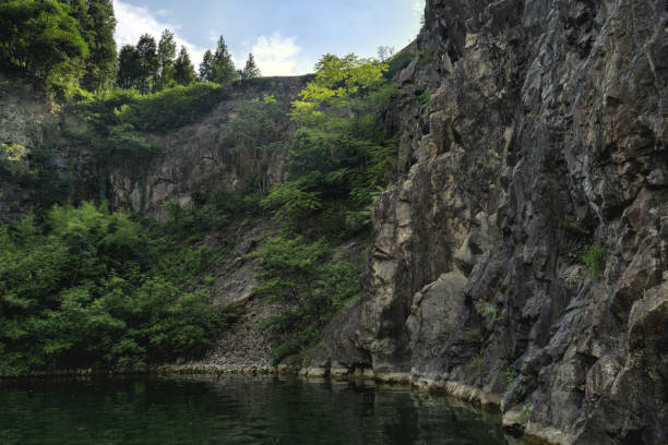 istock Lakeside Quarry Green Landscape under Blue Sky 839371680
