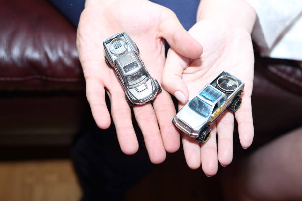 istock Female and man's hands hold car model 839372116