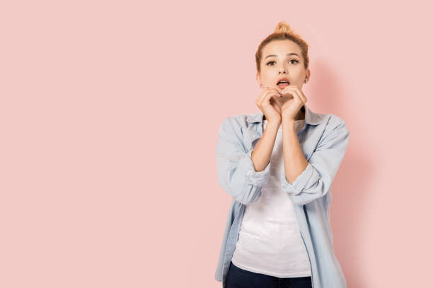 istock Young beautiful woman with hands arranged in heart shape 839381740