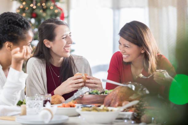 Mid adult woman cracks joke during Christmas dinner