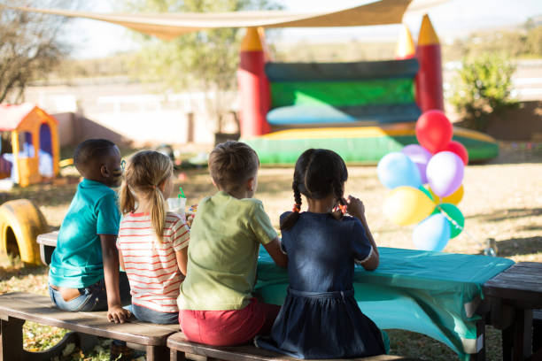 istock Children sitting on bench at park 839391690