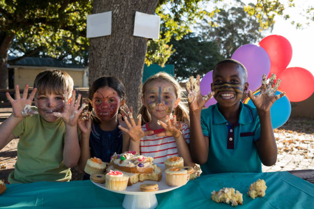 istock Cheerful children gesturing while having sweet food at park 839391844