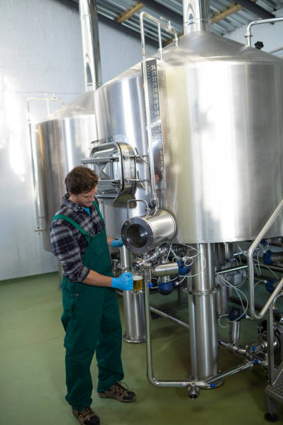 istock Male worker taking beer from storage tank 839392118