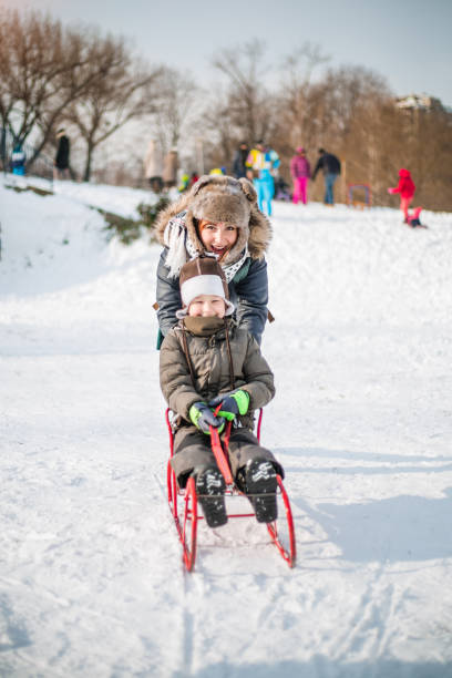 istock Mother and son having fun on snow 839392160