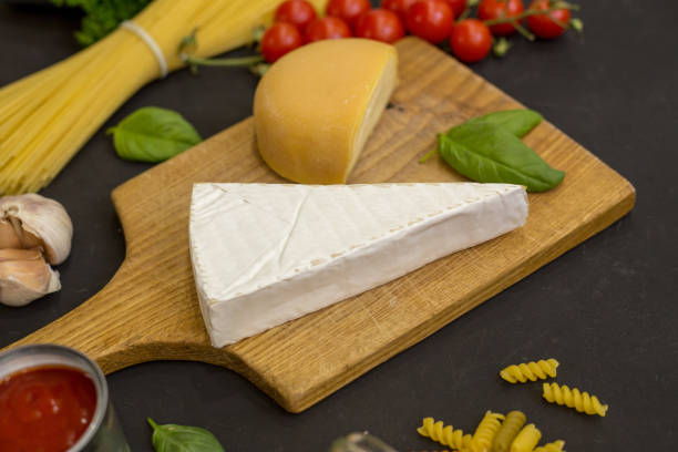 istock Different varieties of cheese on a black board 839403624