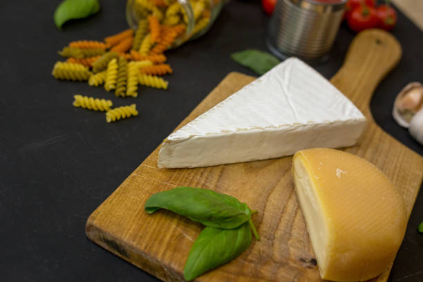 istock Different varieties of cheese on a black board 839404240