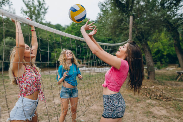 istock Friends playing volleyball at public park 839410412