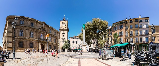 Aix En Provence: people visit the central market place with the famous hotel de ville in Aix en Provence, France.
