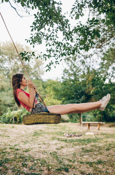 istock Girl swinging on traktor tire 839413494