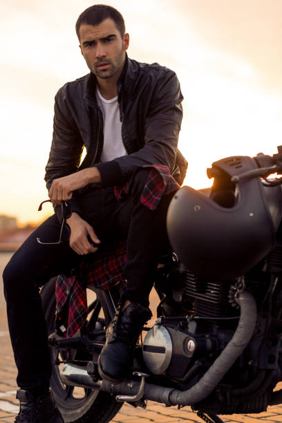 istock Brutal man sit on cafe racer custom motorbike. 839420948