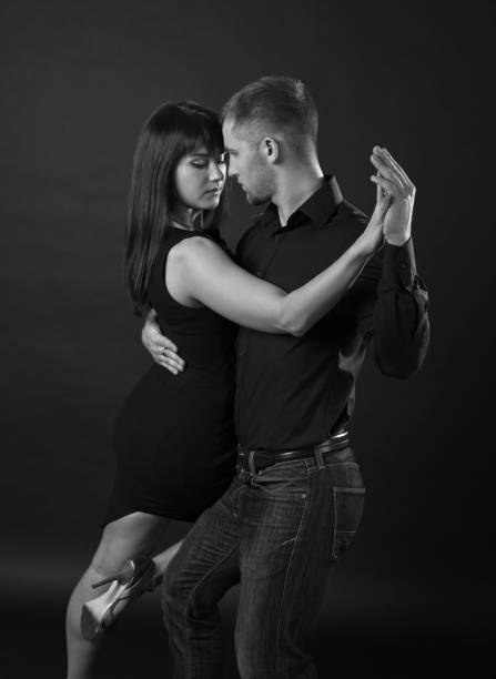 istock Young couple dancing on a dark background 839426996