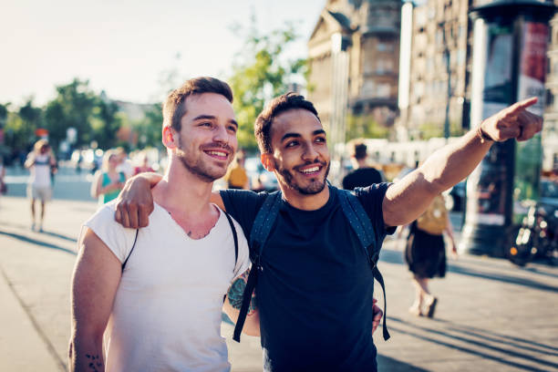 istock Cheerful homosexual couple exploring big city 839432186