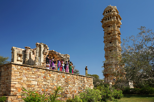 Chittorgarh, India - January 31, 2014: Indian tourists at Chittogarh fort, World Heritage Site, next to the Victory Tower ( Vijay Stambh), Chittorgarh, Rajasthan, India