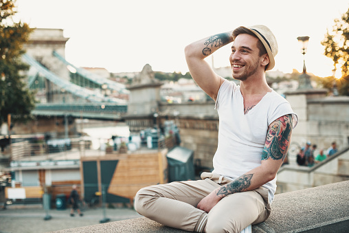 Gay man traveling around Europe and exploring capital cities and places of interest. Homosexual people and friends travel to attractive destinations and making new friendships and relationships with local gay communities.