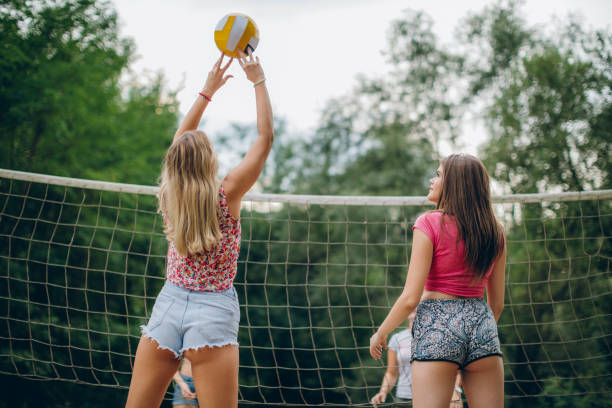 istock Friends playing volleyball at public park 839441508