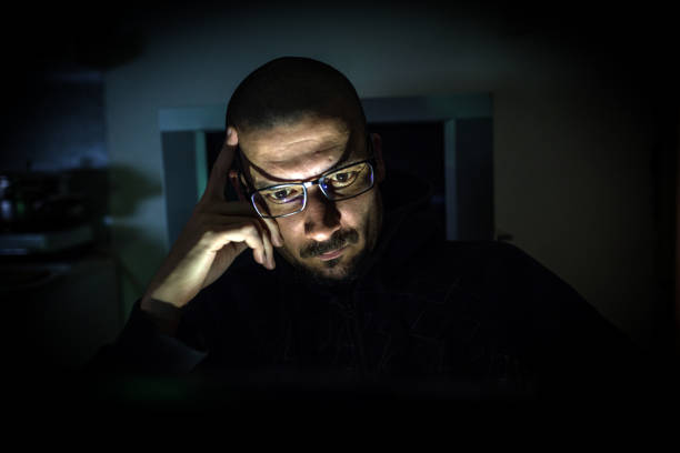istock Hacker attack the server in the dark.Male hacker technology.Anonymous hacker with laptop in the dark. Cyber security concept. 839459790