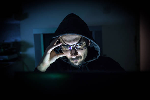 istock Hacker attack the server in the dark.Male hacker technology.Anonymous hacker with laptop in the dark. Cyber security concept. 839459806