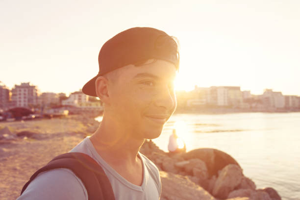 istock happy hipster boy with cap in sunset light 839464136