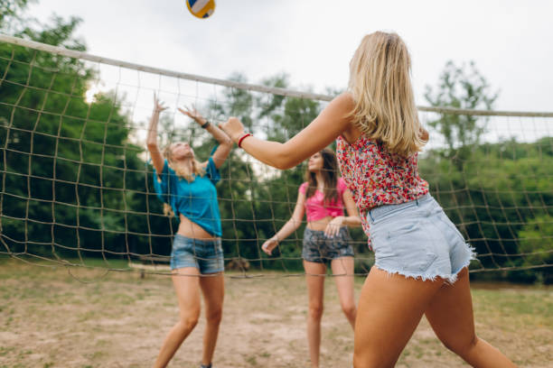 istock Friends playing volleyball at public park 839494810