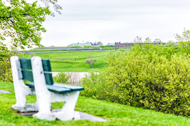 Empty bench in green plaines d'Abraham in morning during summer with view of citadelle in Quebec City