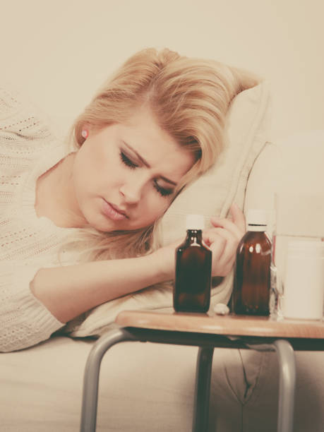 istock Woman being sick having flu lying on sofa 839520296