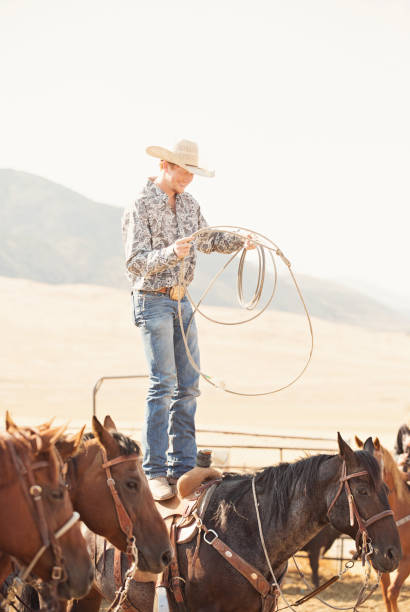 istock Cowboy Standing On His Horse Doing Rope Tricks 839520852