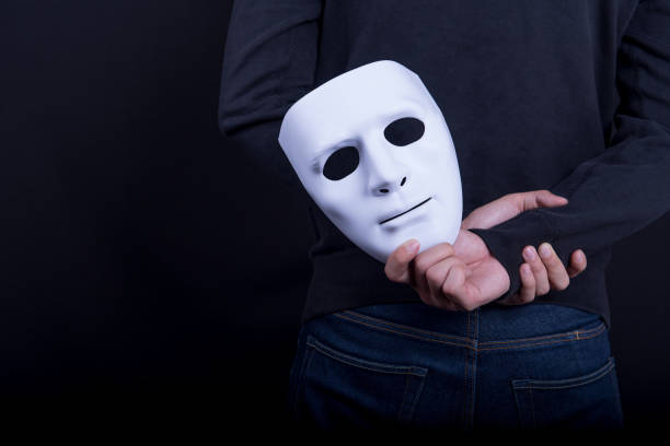 istock Mystery man holding white mask in the back 839562696