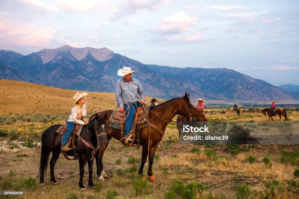 Father and Son Ranchers A father and son look over their ranch on horseback Horseback Riding Stock Photo