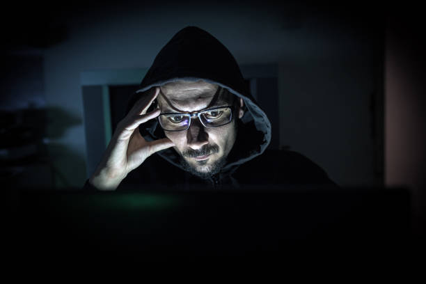 istock Hacker attack the server in the dark.Male hacker technology.Anonymous hacker with laptop in the dark. Cyber security concept. 839637502