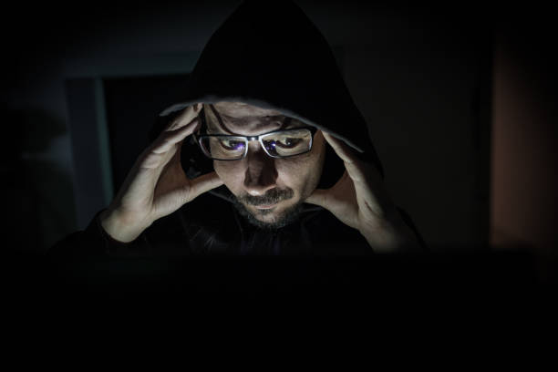 istock Hacker attack the server in the dark.Male hacker technology.Anonymous hacker with laptop in the dark. Cyber security concept. 839637528