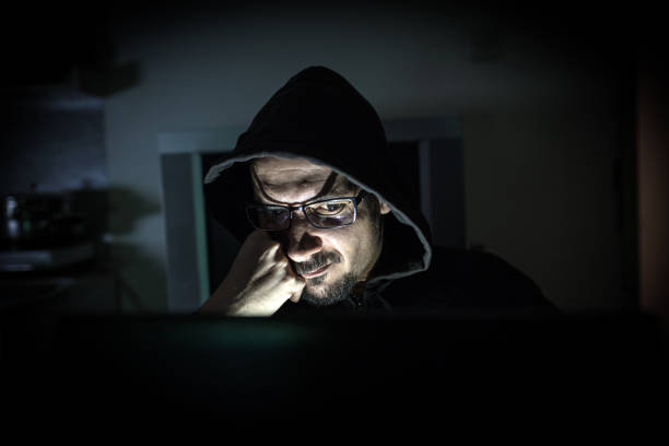 istock Hacker attack the server in the dark.Male hacker technology.Anonymous hacker with laptop in the dark. Cyber security concept. 839637548