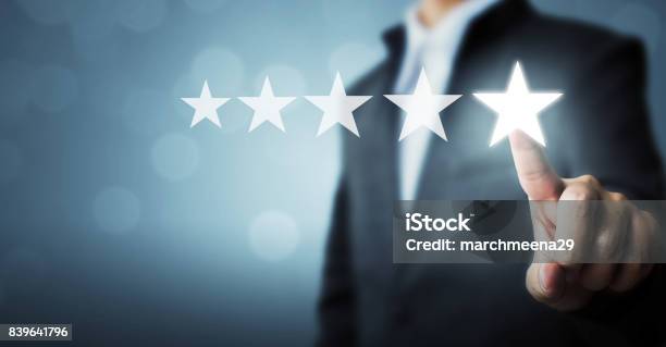 Businessman Pointing Five Star Symbol To Increase Rating Of Company Stock Photo - Download Image Now